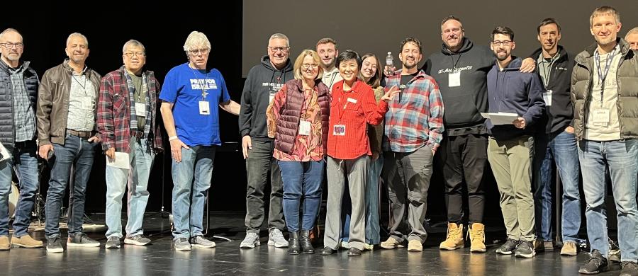 Group photo of a number of the Mission Talk presenters, representatives of over a dozen missions agencies